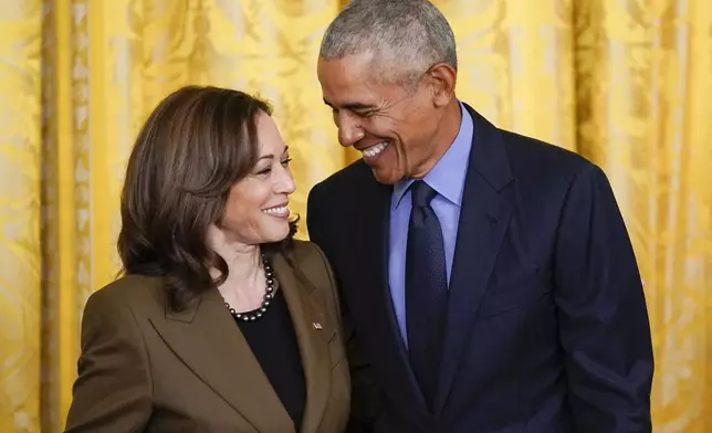 FILE - Former President Barack Obama talks with Vice President Kamala Harris during an event about the Affordable Care Act, in the East Room of the White House in Washington, April 5, 2022. Former President Barack Obama and former first lady Michelle Obama have endorsed Kamala Harris in her White House bid, giving the vice president the expected but still crucial backing of the nation’s two most popular Democrats. (AP Photo/Carolyn Kaster, File)