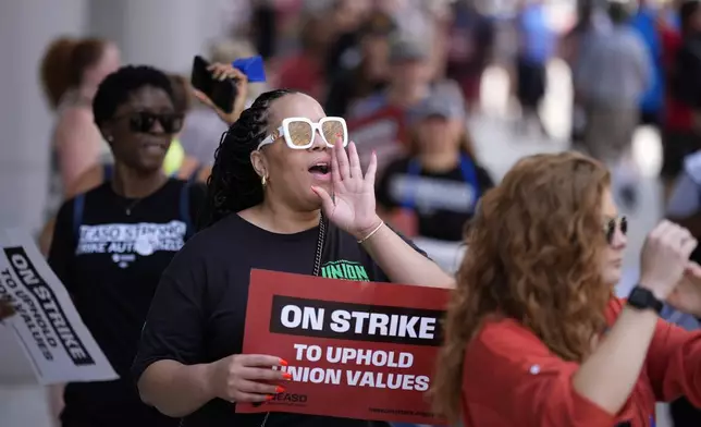 A demonstrator chants while picketing in support of the National Education Association Staff Organization outside the Pennsylvania Convention Center, Friday, July 5, 2024, in Philadelphia. (AP Photo/Matt Slocum)