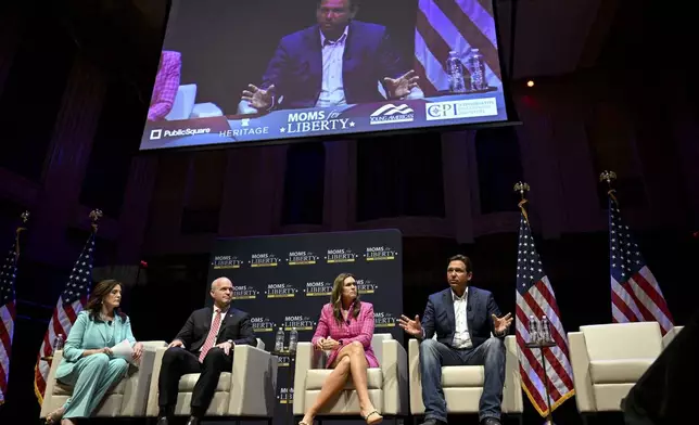 Arkansas Gov. Sarah Huckabee Sanders, second from right, and Florida Gov. Ron DeSantis, right, take questions during a Mom's for Liberty function during the second day of the 2024 Republican National Convention near the Fiserv Forum, Tuesday, July 16, 2024, in Milwaukee. (AP Photo/Joe Lamberti)