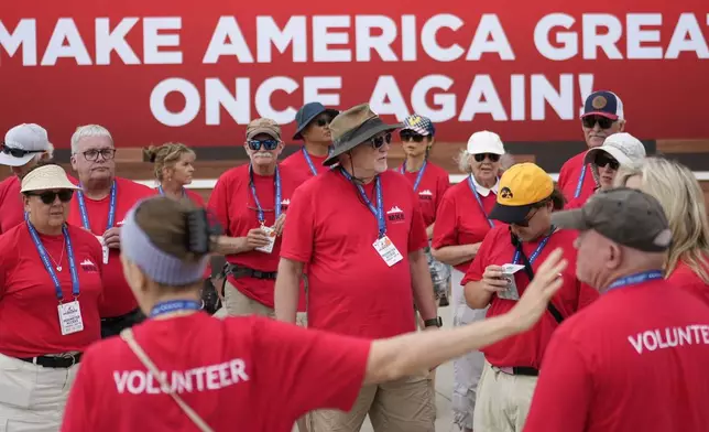 Volunteers gather for a meeting outside the Fiserv Forum during the second day of the 2024 Republican National Convention, Tuesday, July 16, 2024, in Milwaukee. (AP Photo/Jae C. Hong)