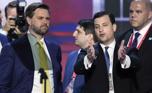 Republican vice presidential candidate Sen. JD Vance, R-Ohio, left, talks with with Danny Tiso, director of press advance for the Trump campaign, right, during the walkthrough for the Republican National Convention Tuesday, July 16, 2024, in Milwaukee. (AP Photo/J. Scott Applewhite)