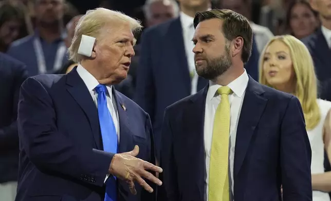 Republican presidential candidate former President Donald Trump is introduced during the Republican National Convention Tuesday, July 16, 2024, in Milwaukee. At right is Republican vice presidential candidate Sen. JD Vance, R-Ohio. (AP Photo/Paul Sancya)