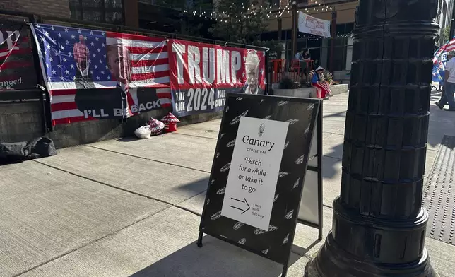 A sign sits on the sidwalk for the Canary Coffee Bar on Thursday, July 18, 2024, in Milwaukee, Wis. This week's Republican National Convention didn't deliver an overwhelming victory to some small businesses in downtown Milwaukee. There had been earlier promises of an economic boost, but some bars, convenience stores and restaurants along the edge of the secure zone sat largely empty all week. (AP Photo/Rio Yamat)