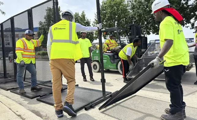 Workers put up fences near the Republican National Convention location on Wednesday, July 10, 2024, in downtown Milwaukee. (AP Photo/Carrie Antlfinger)