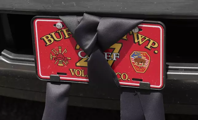 An automobile license plate at the Buffalo Township Fire Company 27 is wrapped in black bunting in Buffalo Township, Pa., Sunday, July 14, 2024. Firefighter Corey Comperatore was killed during a shooting at a campaign rally for Republican presidential candidate former President Donald Trump in Butler, Pa., on Saturday. (AP Photo/Sue Ogrocki)