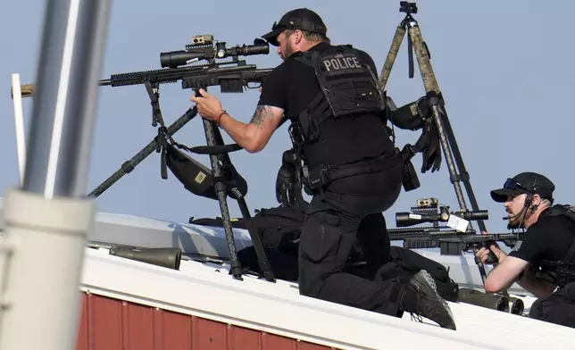 Police snipers return fire after shots were fired while Republican presidential candidate former President Donald Trump was speaking at a campaign event in Butler, Pa., on Saturday, July 13, 2024. (AP Photo/Gene J. Puskar)