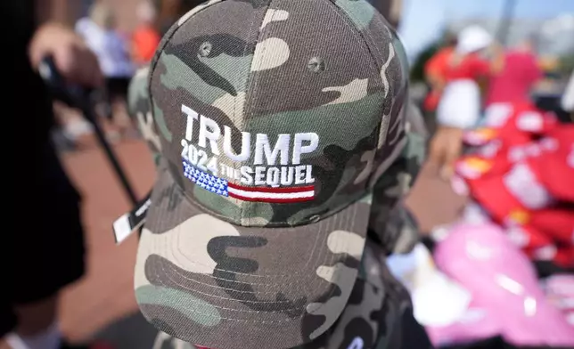 Merchandise is seen on display before Republican presidential candidate former President Donald Trump and Republican vice presidential candidate Sen. JD Vance, R-Ohio, speak at a campaign event, Saturday, July 20, 2024, at Van Andel Arena in Grand Rapids, Mich. (AP Photo/Carlos Osorio)