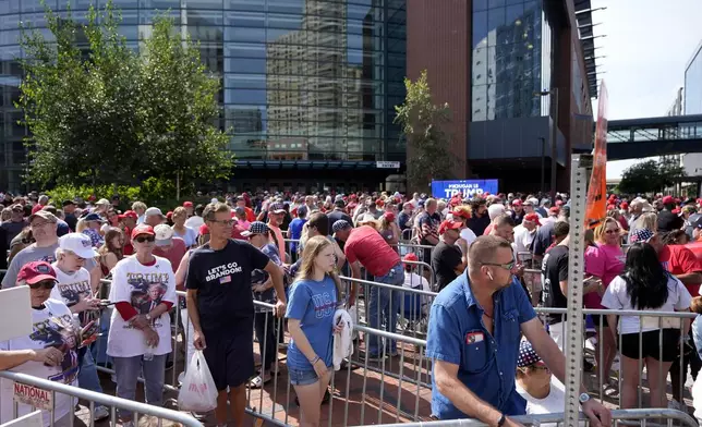 Supporters of Republican presidential candidate former President Donald Trump and Republican vice presidential candidate Sen. JD Vance, R-Ohio, wait in line before a campaign event, Saturday, July 20, 2024, at Van Andel Arena in Grand Rapids, Mich. (AP Photo/Carlos Osorio)