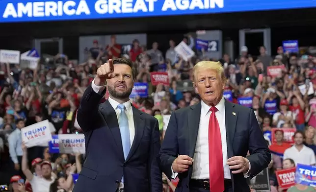 Republican presidential candidate former President Donald Trump and Republican vice presidential candidate Sen. JD Vance, R-Ohio, arrive at a campaign rally, Saturday, July 20, 2024, in Grand Rapids, Mich. (AP Photo/Evan Vucci)