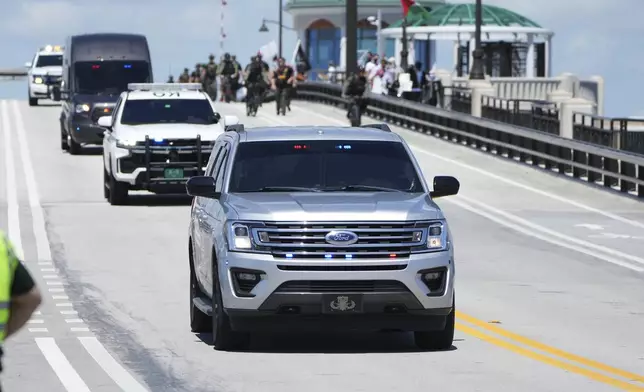 Protesters demonstrate as the motorcade of Israeli Prime Minister Benjamin Netanyahu arrives to meet with former President Donald Trump at Mar-a-Lago, Friday, July 26, 2024, in Palm Beach, Fla. (AP Photo/Jim Rassol)