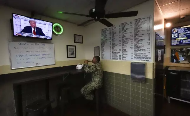 A man watches as Republican presidential candidate former President Donald Trump addresses the Republican National Convention on television at California Burritos restaurant, Thursday, July 18, 2024, in San Diego. (AP Photo/Gregory Bull)