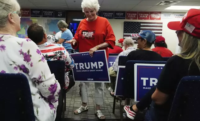 Supporters of Republican presidential candidate former President Donald Trump gather to watch his speech at the Republican National Convention in Milwaukee, from the Arizona GOP headquarters Thursday, July 18, 2024, in Phoenix. (AP Photo/Ross D. Franklin)