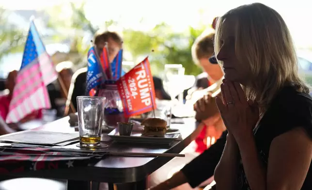 Shannon Cunningham, right, watches the Republican National Convention on television Thursday, July 18, 2024, in Seal Beach, Calif. (AP Photo/Ashley Landis)