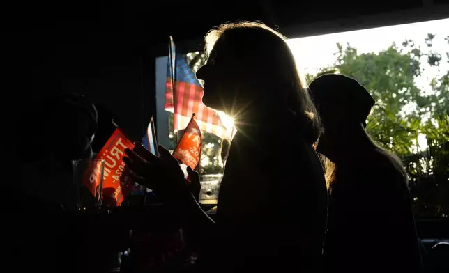 Supporters watch Republican presidential candidate former President Donald Trump speak at the Republican National Convention on a television on Thursday, July 18, 2024, in Seal Beach, Calif. (AP Photo/Ashley Landis)