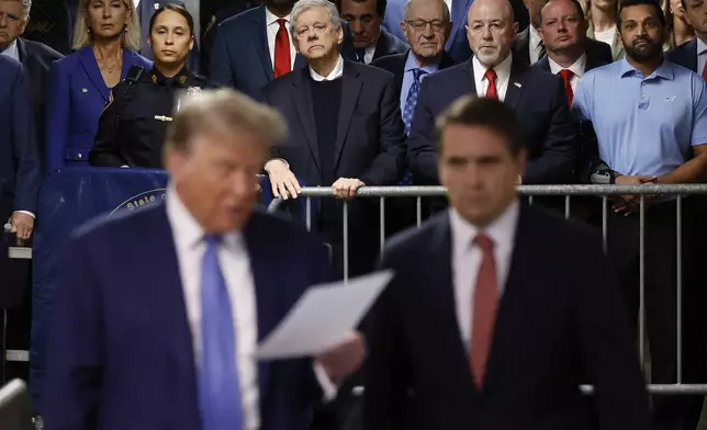 FILE - With Kash Patel at background right, former President Donald Trump speaks to members of the media with his attorney Todd Blanche at Manhattan Criminal Court on Monday, May 20, 2024 in New York. (Michael M. Santiago/Pool Photo via AP, File)