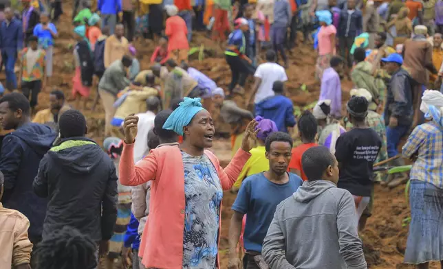 In this handout photo released by Gofa Zone Government Communication Affairs Department, a woman cries as hundreds of people gather at the site of a mudslide in the Kencho Shacha Gozdi district, Gofa Zone, southern Ethiopia, Monday, July 22, 2024. At least 146 people were killed in mudslides in a remote part of Ethiopia that has been hit with heavy rainfall, according to local authorities. (Gofa Zone Government Communication Affairs Department via AP)