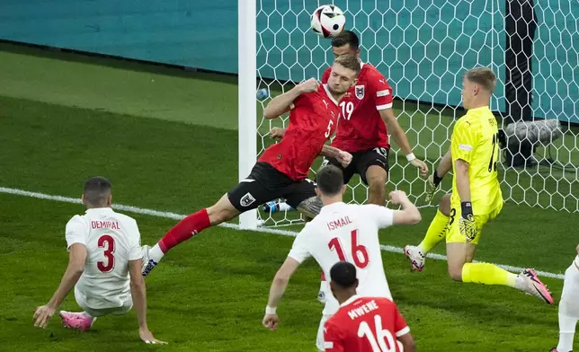 Turkey's Merih Demiral, left, scores the opening goal during a round of sixteen match between Austria and Turkey at the Euro 2024 soccer tournament in Leipzig, Germany, Tuesday, July 2, 2024. (AP Photo/Ebrahim Noroozi)