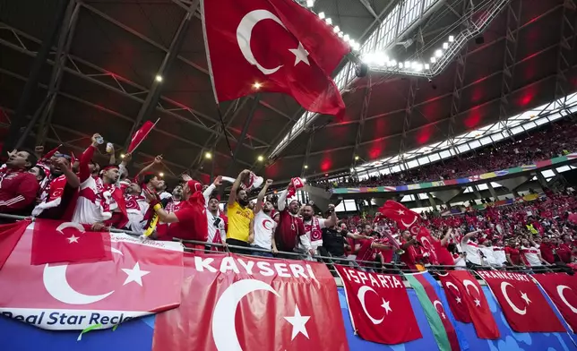 Turkey fans cheer before a round of sixteen match between Austria and Turkey at the Euro 2024 soccer tournament in Leipzig, Germany, Tuesday, July 2, 2024. (AP Photo/Martin Meissner)