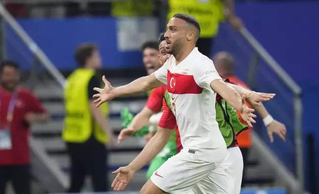 Turkey's Cenk Tosun celebrates after scoring his side's second goal during a Group F match between Czech Republic and Turkey at the Euro 2024 soccer tournament in Hamburg, Germany, Wednesday, June 26, 2024. (AP Photo/Petr David Josek)