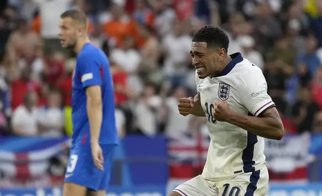 England's Jude Bellingham celebrates after his teammate Harry Kane scores his side's second goal during a round of sixteen match between England and Slovakia at the Euro 2024 soccer tournament in Gelsenkirchen, Germany, Sunday, June 30, 2024. (AP Photo/Antonio Calanni)