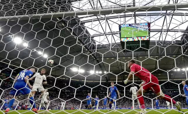 England's Harry Kane, second left, scores his side's second goal during a round of sixteen match between England and Slovakia at the Euro 2024 soccer tournament in Gelsenkirchen, Germany, Sunday, June 30, 2024. (AP Photo/Antonio Calanni)