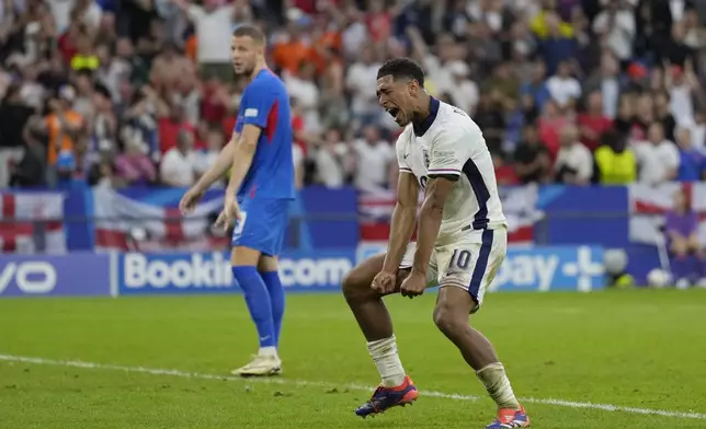 England's Jude Bellingham celebrates after his teammate Harry Kane scores his side's second goal during a round of sixteen match between England and Slovakia at the Euro 2024 soccer tournament in Gelsenkirchen, Germany, Sunday, June 30, 2024. (AP Photo/Antonio Calanni)
