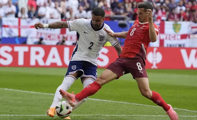 Switzerland's Remo Freuler, rignth, and England's Kyle Walker fight for the ball during a quarterfinal match between England and Switzerland at the Euro 2024 soccer tournament in Duesseldorf, Germany, Saturday, July 6, 2024. (AP Photo/Martin Meissner)