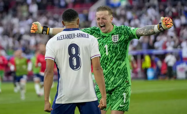 England's goalkeeper Jordan Pickford, right, celebrates with tEngland's Trent Alexander-Arnold after a quarterfinal match between England and Switzerland at the Euro 2024 soccer tournament in Duesseldorf, Germany, Saturday, July 6, 2024. (AP Photo/Darko Vojinovic)