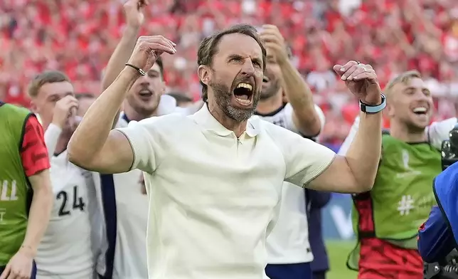 England's manager Gareth Southgate celebrates after winning the penalty shootout of a quarterfinal match between England and Switzerland at the Euro 2024 soccer tournament in Duesseldorf, Germany, Saturday, July 6, 2024. (AP Photo/Martin Meissner)