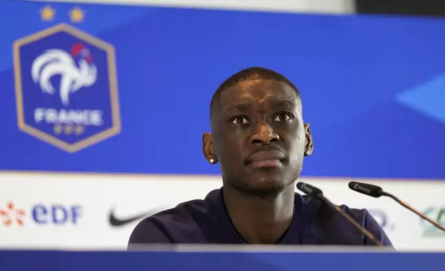 France's Randal Kolo Muani gestures as he speaks during a press conference in Paderborn, Germany, Sunday, July 7, 2024. France will play against Spain during their semifinal soccer match at the Euro 2024 soccer tournament on July 9. (AP Photo/Hassan Ammar)