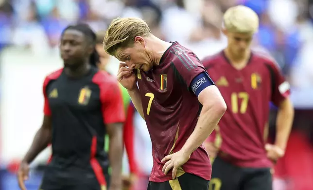 Belgium's Kevin De Bruyne, center, and his teammates react after a round of sixteen match between France and Belgium at the Euro 2024 soccer tournament in Duesseldorf, Germany, Monday, July 1, 2024. (Rolf Vennenbernd/dpa via AP)