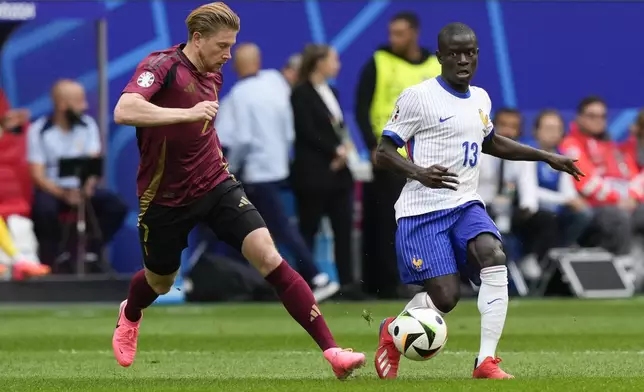Belgium's Kevin De Bruyne, left, and N'Golo Kante of France vie for the ball during a round of sixteen match between France and Belgium at the Euro 2024 soccer tournament in Duesseldorf, Germany, Monday, July 1, 2024. (AP Photo/Frank Augstein)