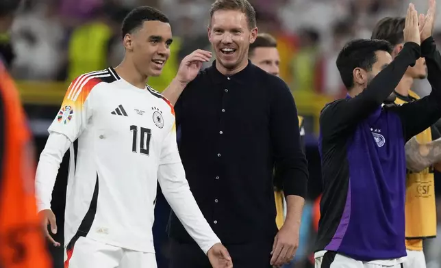 Germany's head coach Julian Nagelsmann, center, and Jamal Musiala celebrate after a round of sixteen match between Germany and Denmark at the Euro 2024 soccer tournament in Dortmund, Germany, Saturday, June 29, 2024. Germany won 2-0. (AP Photo/Frank Augstein)