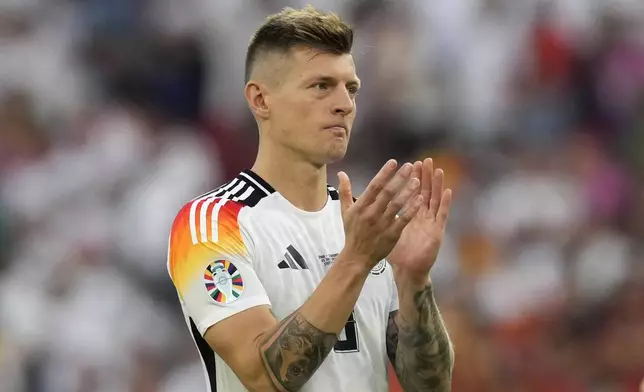 Germany's Toni Kroos clap hands as he acknowledges supporters at the end of a quarter final match between Germany and Spain at the Euro 2024 soccer tournament in Stuttgart, Germany, Friday, July 5, 2024. (AP Photo/Ariel Schalit)