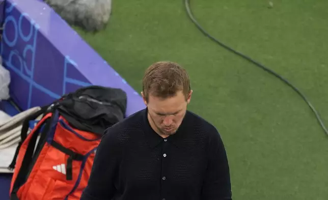 Germany's head coach Julian Nagelsmann walks into the tunnel at the end of a quarter final match between Germany and Spain at the Euro 2024 soccer tournament in Stuttgart, Germany, Friday, July 5, 2024. Spain won the game 2-1. (AP Photo/Michael Probst)