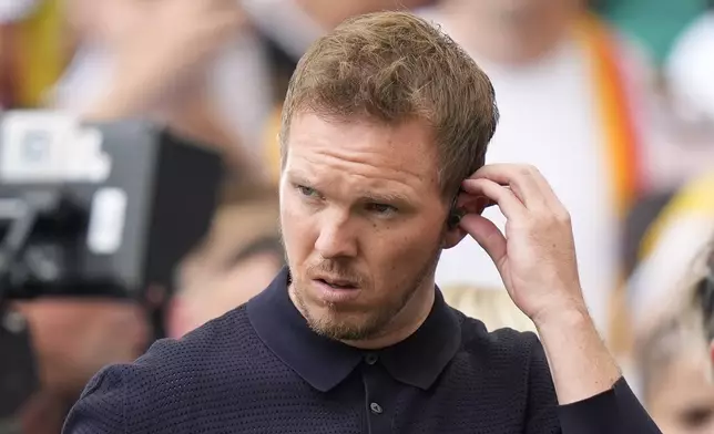 Germany's head coach Julian Nagelsmann attends an interview on the pitch before a quarter final match between Germany and Spain at the Euro 2024 soccer tournament in Stuttgart, Germany, Friday, July 5, 2024. (AP Photo/Matthias Schrader)