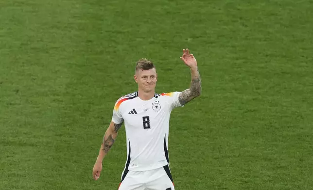 Germany's Toni Kroos waves at the end of a quarter final match between Germany and Spain at the Euro 2024 soccer tournament in Stuttgart, Germany, Friday, July 5, 2024. Spain won the team 2-1. (AP Photo/Michael Probst)