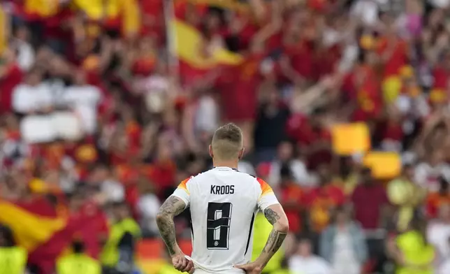 Germany's Toni Kroos watches fans celebrate at the end of a quarter final match between Germany and Spain at the Euro 2024 soccer tournament in Stuttgart, Germany, Friday, July 5, 2024. (AP Photo/Ariel Schalit)