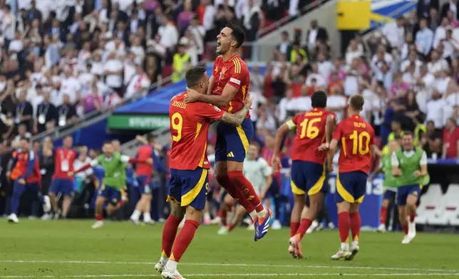 Spain's players celebrate at the end of a quarter final match between Germany and Spain at the Euro 2024 soccer tournament in Stuttgart, Germany, Friday, July 5, 2024. (AP Photo/Ariel Schalit)