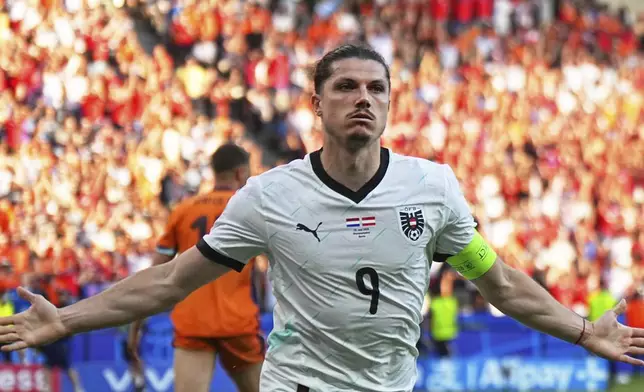 Austria's Marcel Sabitzer celebrates after scoring his side's third goal during a Group D match between the Netherlands and Austria at the Euro 2024 soccer tournament in Berlin, Germany, Tuesday, June 25, 2024. (Michael Kappeler/dpa via AP)