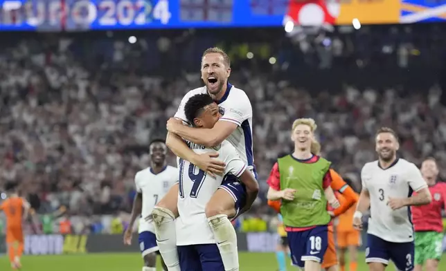 England's Harry Kane celebrates in the arms of teammate Ollie Watkins at the end of a semifinal match between the Netherlands and England at the Euro 2024 soccer tournament in Dortmund, Germany, Wednesday, July 10, 2024. England won 2-1. (AP Photo/Martin Meissner)