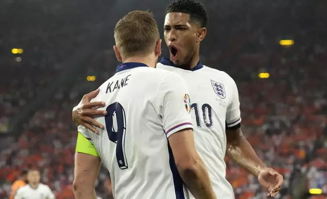 England's Harry Kane celebrates with England's Jude Bellingham, right, after scoring his sides first goal during a semifinal match between the Netherlands and England at the Euro 2024 soccer tournament in Dortmund, Germany, Wednesday, July 10, 2024. (AP Photo/Frank Augstein)