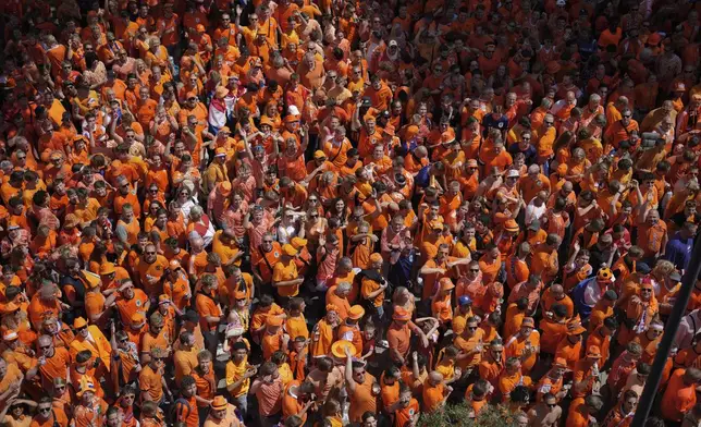 Netherlands fans celebrate at the city center ahead of a semi final match between Netherlands and England at the Euro 2024 soccer tournament in Dortmund, Germany, Wednesday, July 10, 2024. (AP Photo/Markus Schreiber)