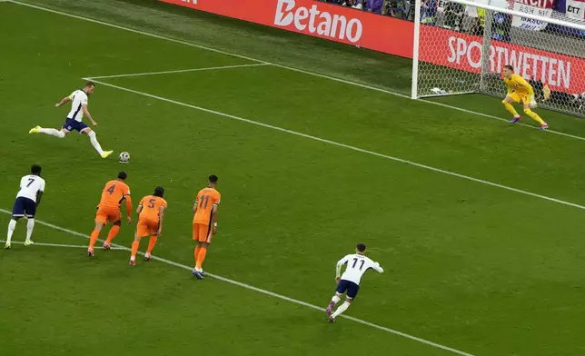 England's Harry Kane shoots to score his sides first goal during a semifinal match between the Netherlands and England at the Euro 2024 soccer tournament in Dortmund, Germany, Wednesday, July 10, 2024. (AP Photo/Hassan Ammar)