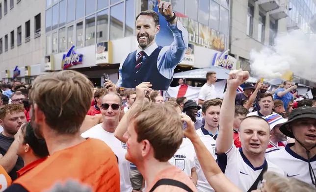 An England fan shows a placard of national coach Gareth Southgate during celebration ahead of a semi final match between Netherlands and England at the Euro 2024 soccer tournament in Dortmund, Germany, Wednesday, July 10, 2024. (AP Photo/Markus Schreiber)