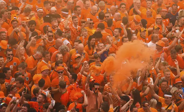 Netherlands fans celebrate at the Friedensplatz in the city center ahead of a semifinal match between Netherlands and England at the Euro 2024 soccer tournament in Dortmund, Germany, Wednesday, July 10, 2024. (AP Photo/Markus Schreiber)