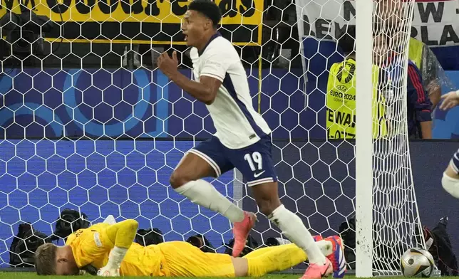 England's Ollie Watkins, center, celebrates after scoring his sides second goal past Netherlands goalkeeper Bart Verbruggen during a semifinal match between the Netherlands and England at the Euro 2024 soccer tournament in Dortmund, Germany, Wednesday, July 10, 2024. (AP Photo/Frank Augstein)