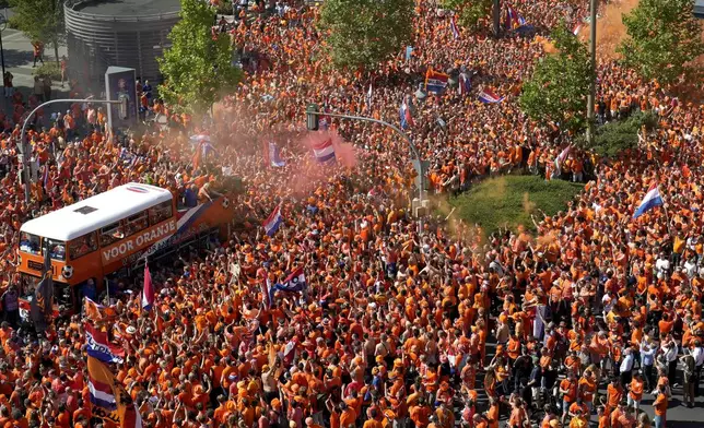 Fans of the team of the Netherlands gather for a fan walk towards the stadium ahead of a semifinal match between Netherlands and England at the Euro 2024 soccer tournament in Dortmund, Germany, Wednesday, July 10, 2024. (AP Photo/Markus Schreiber)