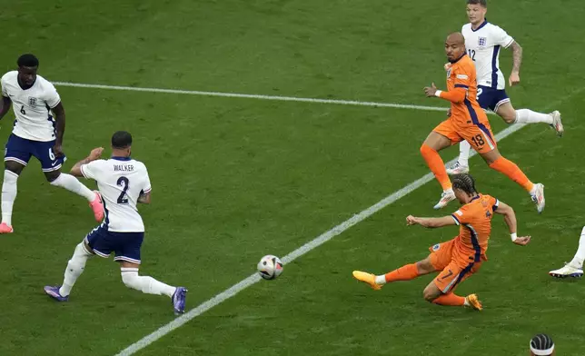 Xavi Simons of the Netherlands scores the opening goal during a semifinal match between the Netherlands and England at the Euro 2024 soccer tournament in Dortmund, Germany, Wednesday, July 10, 2024. (AP Photo/Hassan Ammar)