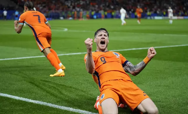 Wout Weghorst of the Netherlands, celebrates after an own goal by Turkey's Mert Muldur during a quarterfinal match between the Netherlands and Turkey at the Euro 2024 soccer tournament in Berlin, Germany, Saturday, July 6, 2024. (AP Photo/Ebrahim Noroozi)